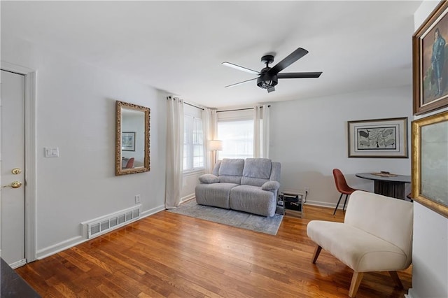 831 E 25th Ave, North Kansas City, MO 64116 - sitting room featuring wood finished floors, a ceiling fan, and baseboards