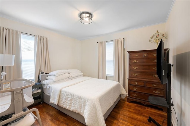 831 E 25th Ave, North Kansas City, MO 64116 - bedroom featuring dark wood-style floors and crown molding