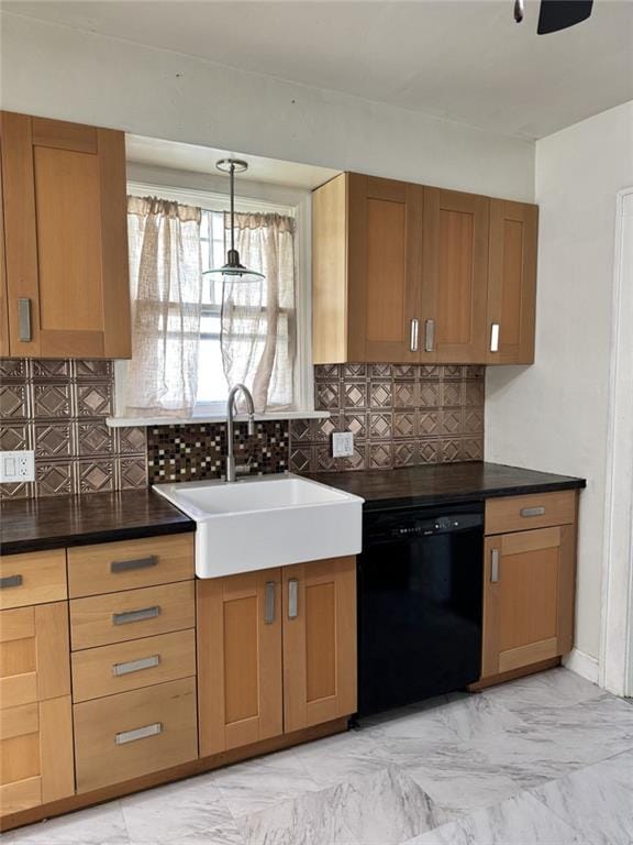 kitchen with black dishwasher, a sink, dark countertops, and decorative backsplash