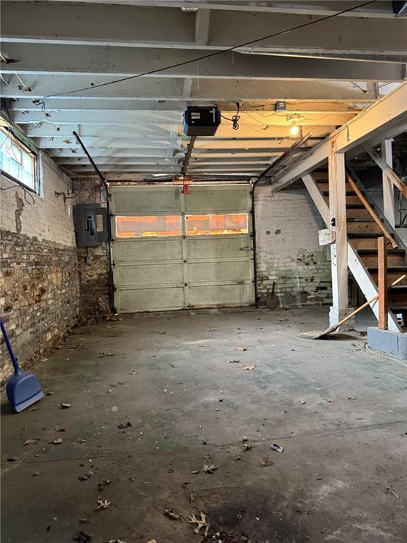 garage featuring a garage door opener and electric panel