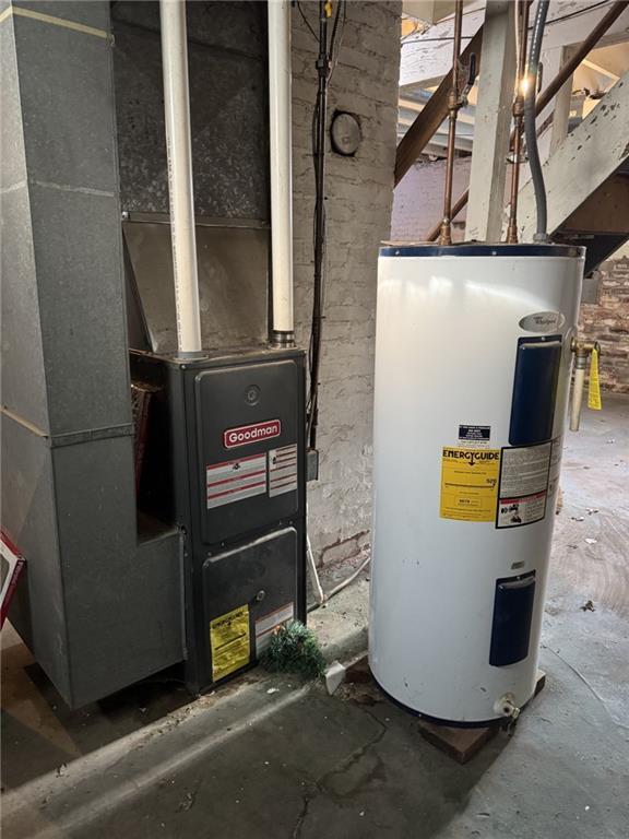 utility room with electric water heater and heating unit