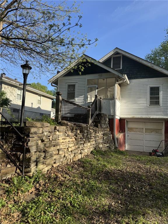 view of front facade with an attached garage and stairway
