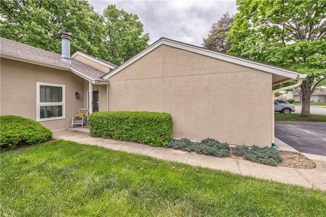 12735 W 108th Pl, Overland Park, KS 66210 - view of side of home with a yard and stucco siding