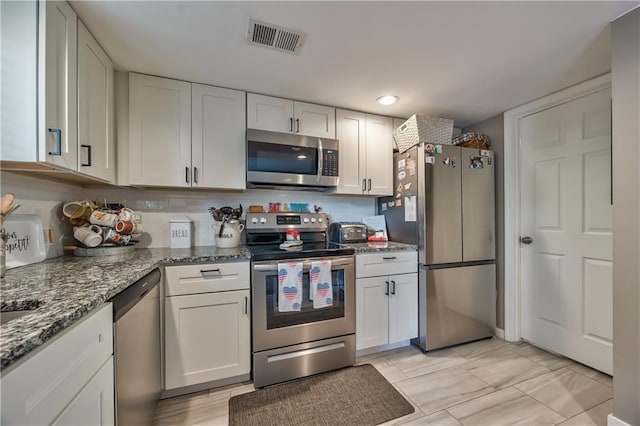 12735 W 108th Pl, Overland Park, KS 66210 - kitchen featuring stainless steel appliances, white cabinets, and light stone countertops