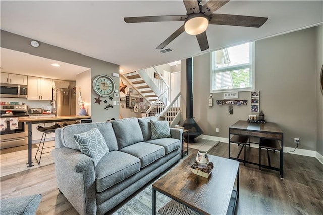 12735 W 108th Pl, Overland Park, KS 66210 - living room featuring a ceiling fan, wood finished floors, stairs, baseboards, and recessed lighting