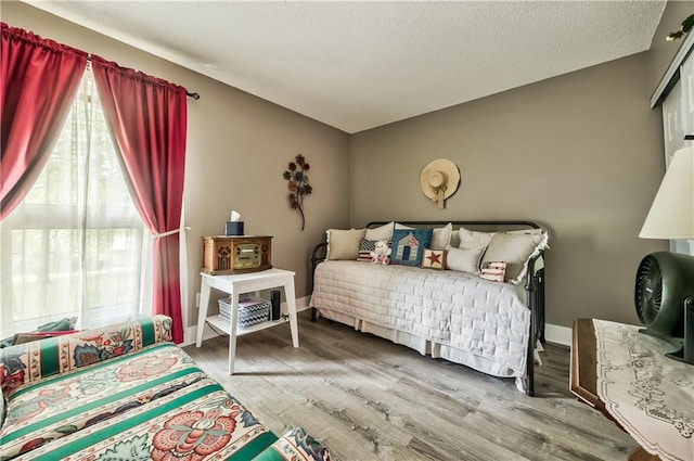12735 W 108th Pl, Overland Park, KS 66210 - bedroom featuring wood finished floors and a textured ceiling
