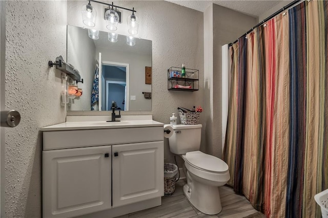 12735 W 108th Pl, Overland Park, KS 66210 - full bathroom featuring a textured wall, toilet, wood finished floors, vanity, and curtained shower