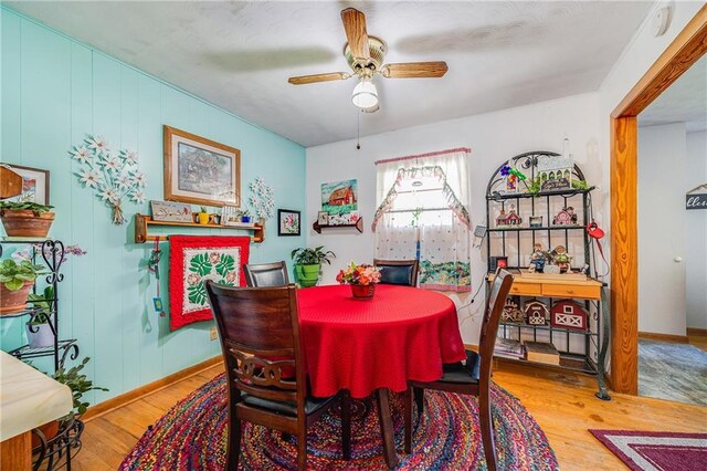 603 W 30th St, Higginsville, MO 64037 - dining space with wood finished floors, a ceiling fan, and baseboards