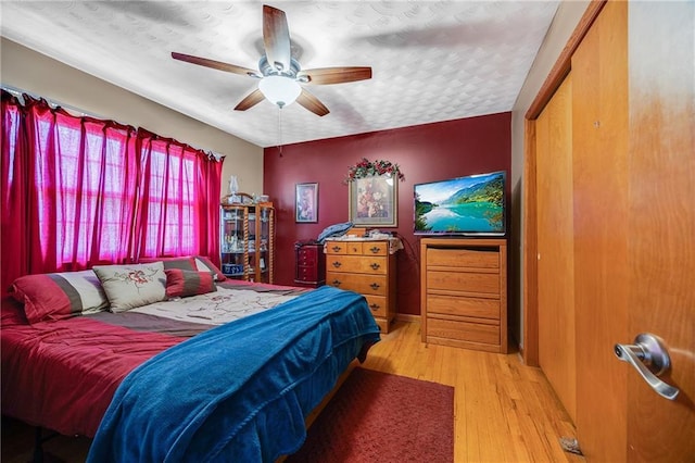 603 W 30th St, Higginsville, MO 64037 - bedroom with wood finished floors, a textured ceiling, and a ceiling fan