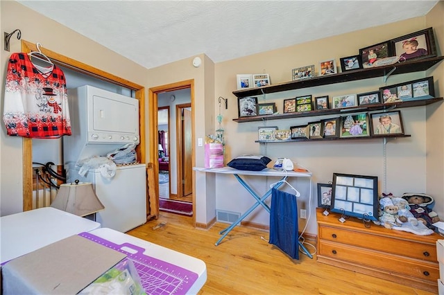 603 W 30th St, Higginsville, MO 64037 - bedroom with stacked washer / dryer and wood finished floors