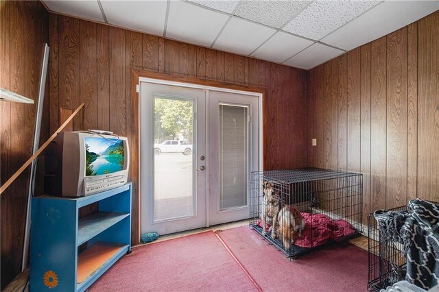 603 W 30th St, Higginsville, MO 64037 - doorway to outside with french doors, carpet flooring, and wood walls