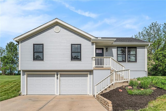 single story home with a garage, concrete driveway, and a front yard
