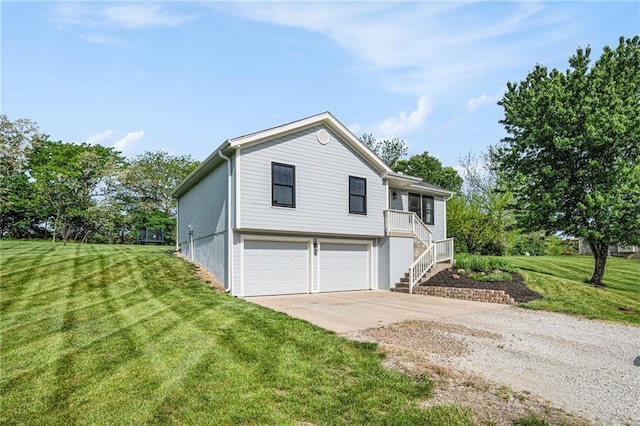 view of side of home featuring a garage, concrete driveway, stairway, and a lawn
