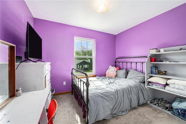 bedroom featuring carpet floors and baseboards
