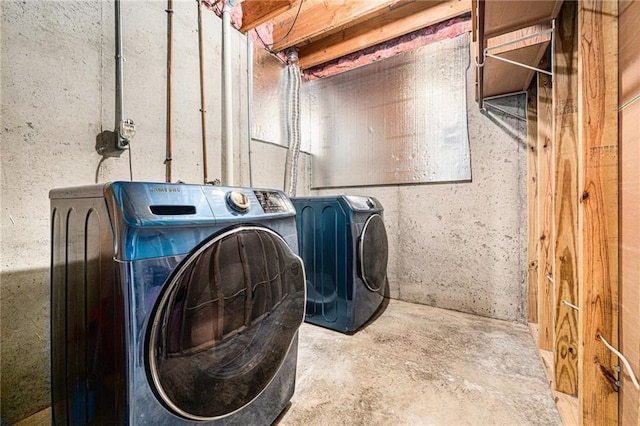 clothes washing area featuring washer and clothes dryer