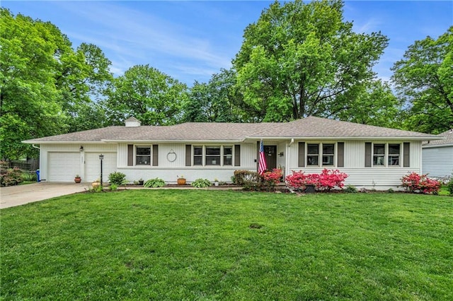 ranch-style house featuring an attached garage, driveway, a front yard, and a chimney