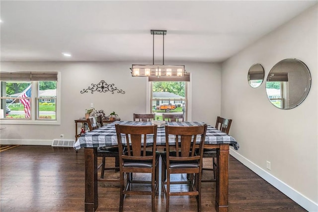 dining room with recessed lighting, dark wood-style flooring, and baseboards