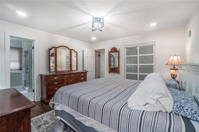 bedroom with wood finished floors, recessed lighting, and connected bathroom