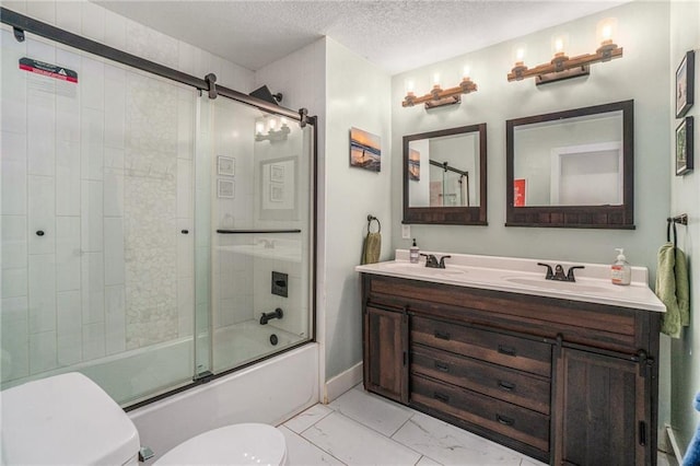 bathroom featuring toilet, marble look tiles, enclosed tub / shower combo, double vanity, and a textured ceiling