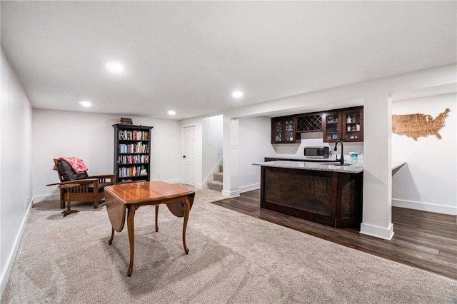 carpeted home office with recessed lighting, baseboards, and wood finished floors