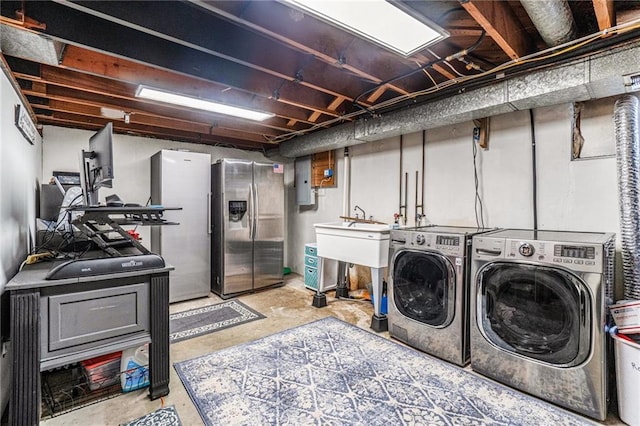 laundry room with washing machine and clothes dryer and electric panel