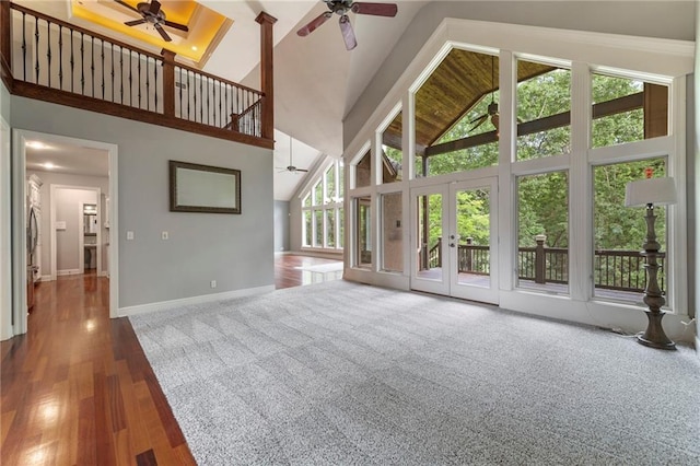 8129 Clearwater Pt, Parkville, MO 64152 - unfurnished living room with a ceiling fan, high vaulted ceiling, and wood finished floors