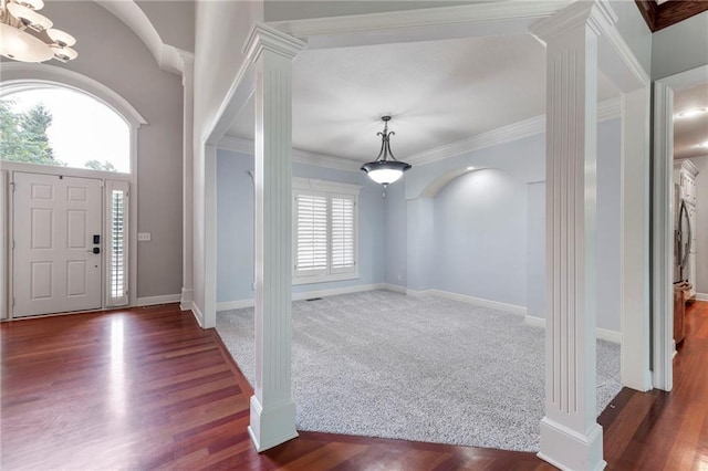 8129 Clearwater Pt, Parkville, MO 64152 - foyer entrance featuring ornate columns, a chandelier, ornamental molding, and wood finished floors