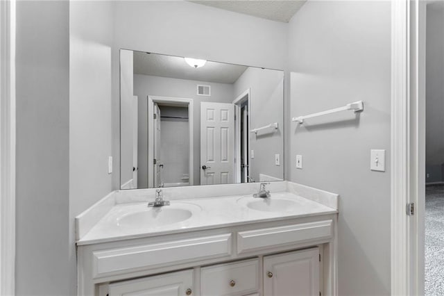8129 Clearwater Pt, Parkville, MO 64152 - bathroom featuring double vanity and a textured ceiling