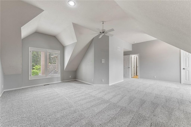 8129 Clearwater Pt, Parkville, MO 64152 - bonus room with lofted ceiling, a ceiling fan, carpet floors, and a textured ceiling