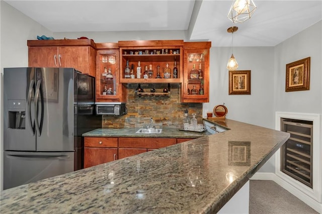 8129 Clearwater Pt, Parkville, MO 64152 - indoor wet bar with refrigerator with ice dispenser, wine cooler, tasteful backsplash, carpet, and pendant lighting
