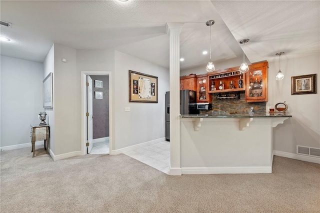 8129 Clearwater Pt, Parkville, MO 64152 - kitchen with light colored carpet, refrigerator with ice dispenser, a kitchen bar, decorative backsplash, and stainless steel microwave