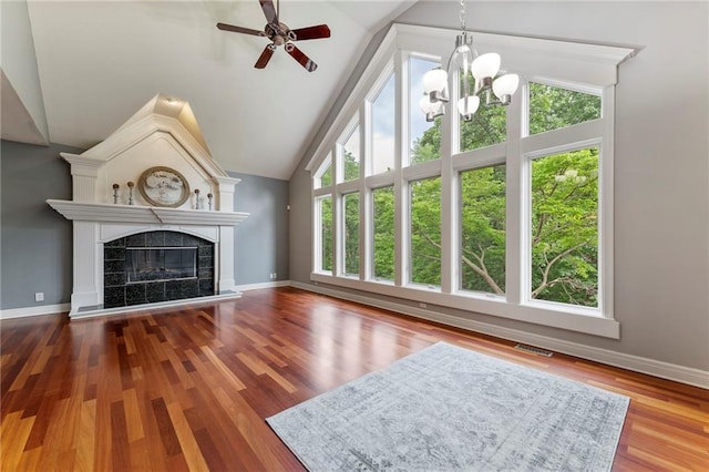8129 Clearwater Pt, Parkville, MO 64152 - unfurnished living room with lofted ceiling, a chandelier, ceiling fan, a high end fireplace, and wood finished floors