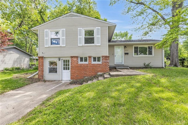 4203 E 113th St, Kansas City, MO 64137 - tri-level home with brick siding and a front lawn