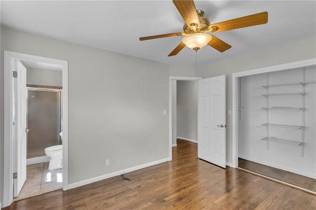 4203 E 113th St, Kansas City, MO 64137 - unfurnished bedroom with a closet, connected bathroom, wood finished floors, and baseboards
