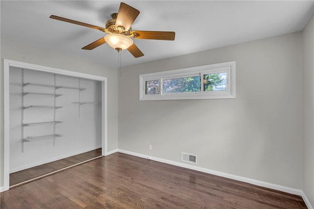 4203 E 113th St, Kansas City, MO 64137 - unfurnished bedroom with wood finished floors, baseboards, a closet, and ceiling fan
