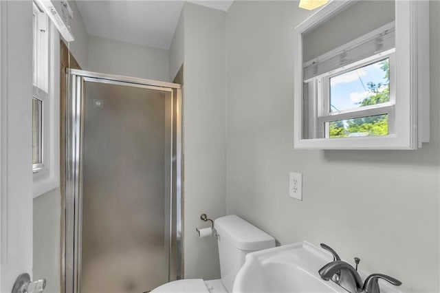 4203 E 113th St, Kansas City, MO 64137 - bathroom featuring a shower stall, toilet, and a sink