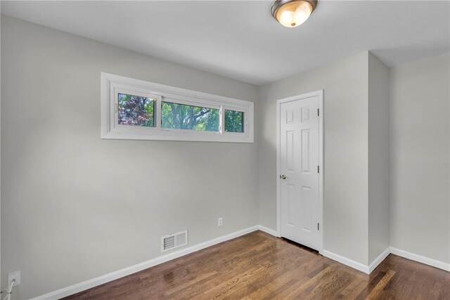 4203 E 113th St, Kansas City, MO 64137 - spare room with baseboards and dark wood finished floors