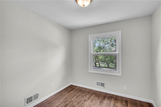 4203 E 113th St, Kansas City, MO 64137 - spare room with baseboards and wood finished floors