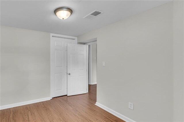 4203 E 113th St, Kansas City, MO 64137 - spare room with baseboards and wood finished floors