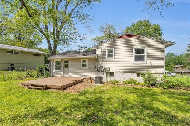 4203 E 113th St, Kansas City, MO 64137 - rear view of property with a deck and central AC unit