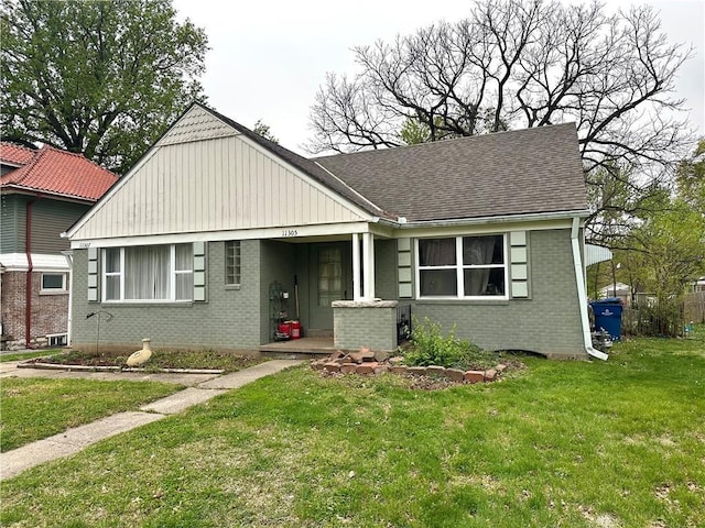 11305 E Winner Rd, Independence, MO 64052 - bungalow with brick siding, a front yard, and a shingled roof