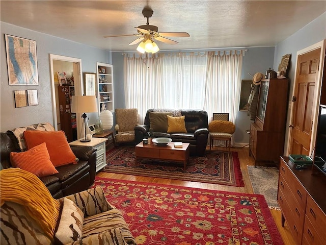 11305 E Winner Rd, Independence, MO 64052 - living area with healthy amount of natural light, wood finished floors, and a ceiling fan