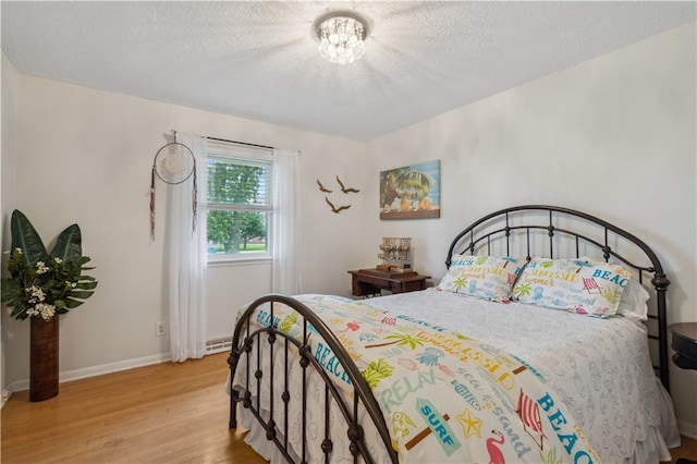 2113 N 155th St, Basehor, KS 66007 - bedroom featuring light wood finished floors, a textured ceiling, and baseboards