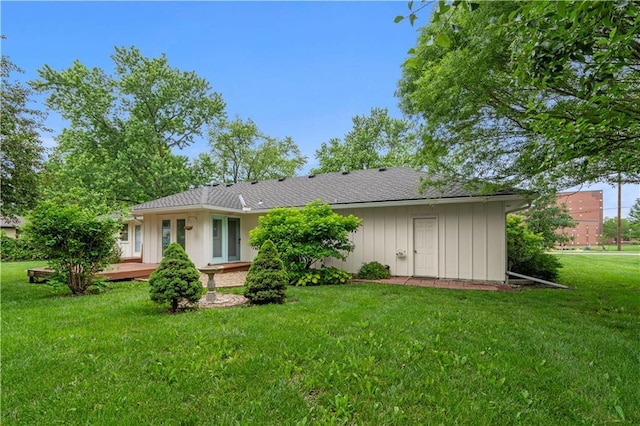 2113 N 155th St, Basehor, KS 66007 - back of house with a wooden deck, board and batten siding, and a lawn