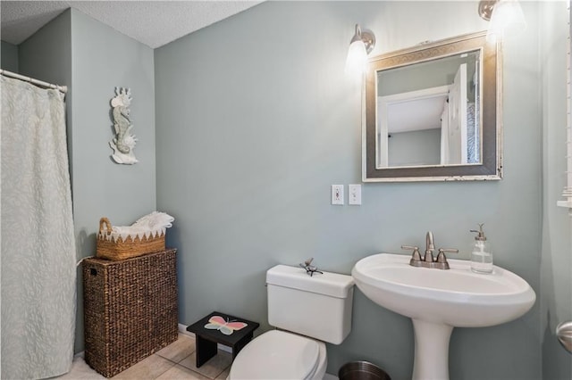 2113 N 155th St, Basehor, KS 66007 - full bath with toilet, tile patterned floors, and a textured ceiling