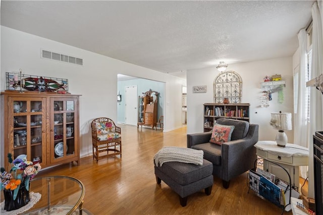 2113 N 155th St, Basehor, KS 66007 - living room with wood finished floors, a textured ceiling, and baseboards