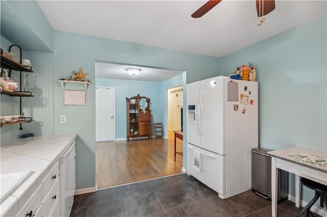 2113 N 155th St, Basehor, KS 66007 - kitchen featuring white refrigerator with ice dispenser, tile counters, open shelves, white cabinetry, and a ceiling fan