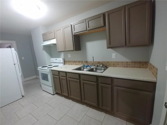 2708 Benton Blvd, Kansas City, MO 64128 - kitchen featuring white appliances, a sink, under cabinet range hood, light countertops, and light tile patterned floors