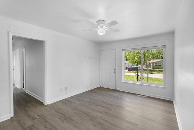 2729 S 52nd St, Kansas City, KS 66106 - spare room featuring wood finished floors, ceiling fan, and baseboards