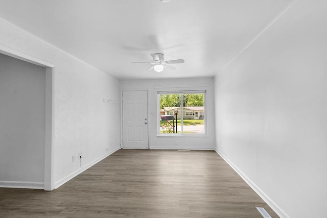 2729 S 52nd St, Kansas City, KS 66106 - spare room featuring a ceiling fan, wood finished floors, and baseboards
